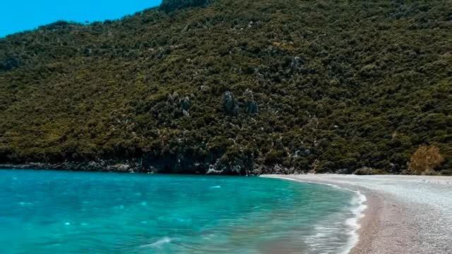 Turquoise water and a quiet beach featured in the Instagram Reel